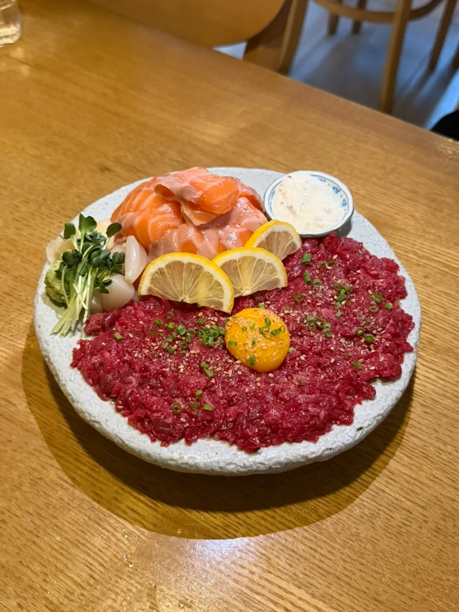 Salmon sashimi and beef tartare topped with egg yolk