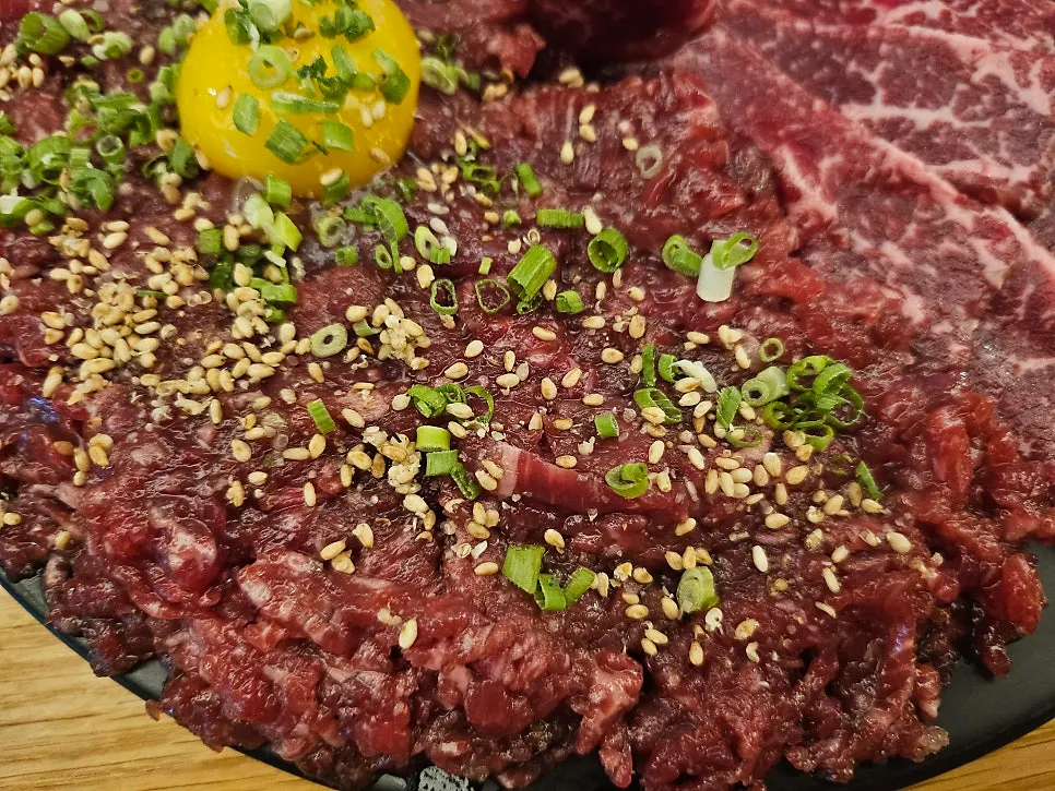 Beef sashimi served with sesame oil salt sauce and seaweed