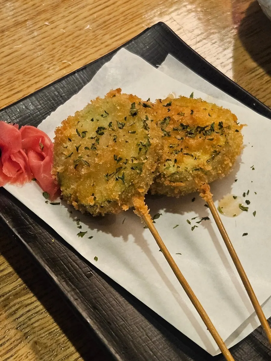 A piece of mackerel bong-sushi eaten with vinegared ginger on top