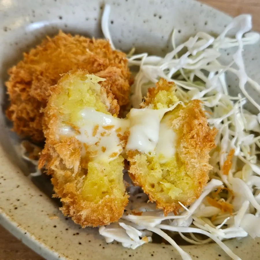 Cross-section of the croquette showing melted cheese and sweet potato filling