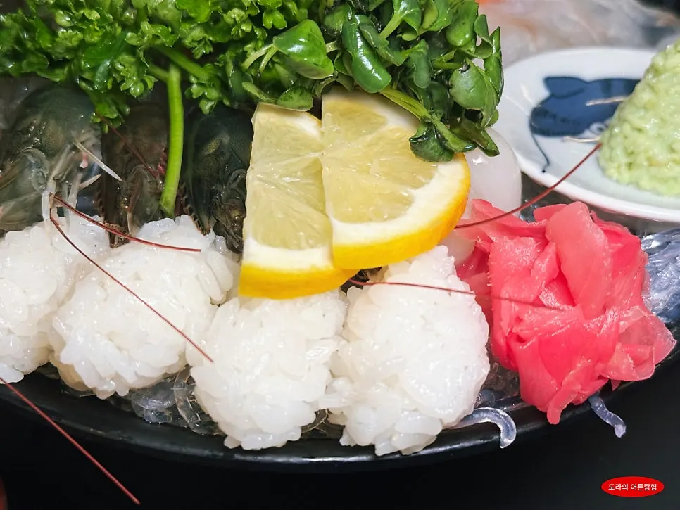 Lemon, pickled ginger, pickled scallions, wasabi and sushi rice on the side