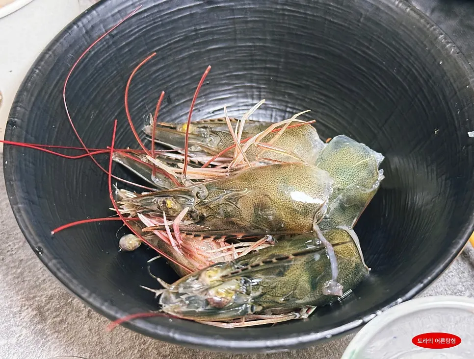 Shrimp heads set aside with plastic gloves