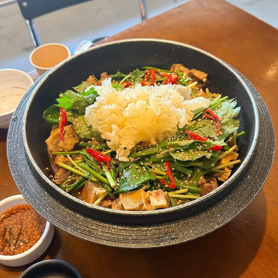 A table of banchan including stir-fried anchovies