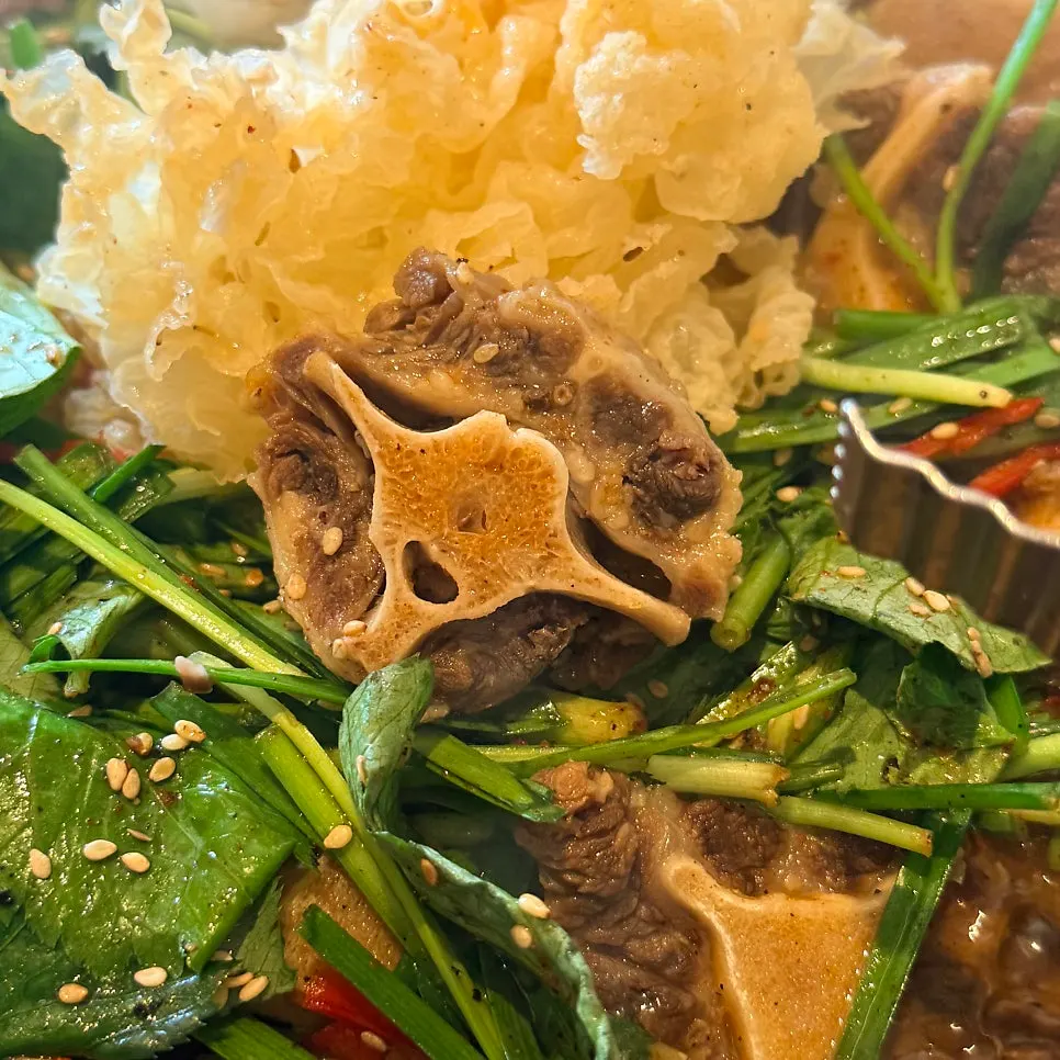 A table set with both ox tail suyuk and yukhoe bibimbap