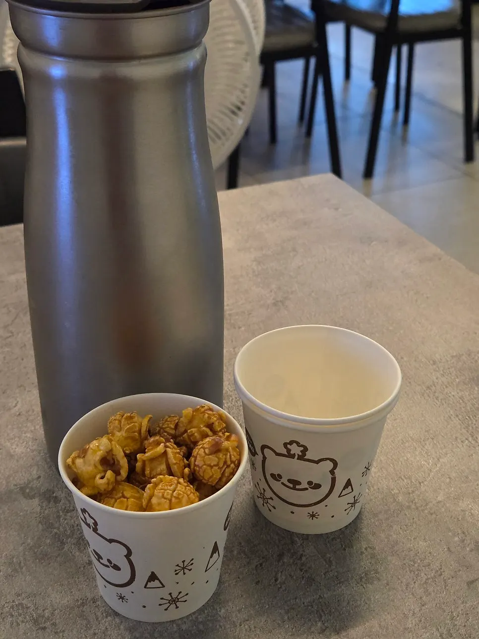 Caramel popcorn starter served in a paper cup