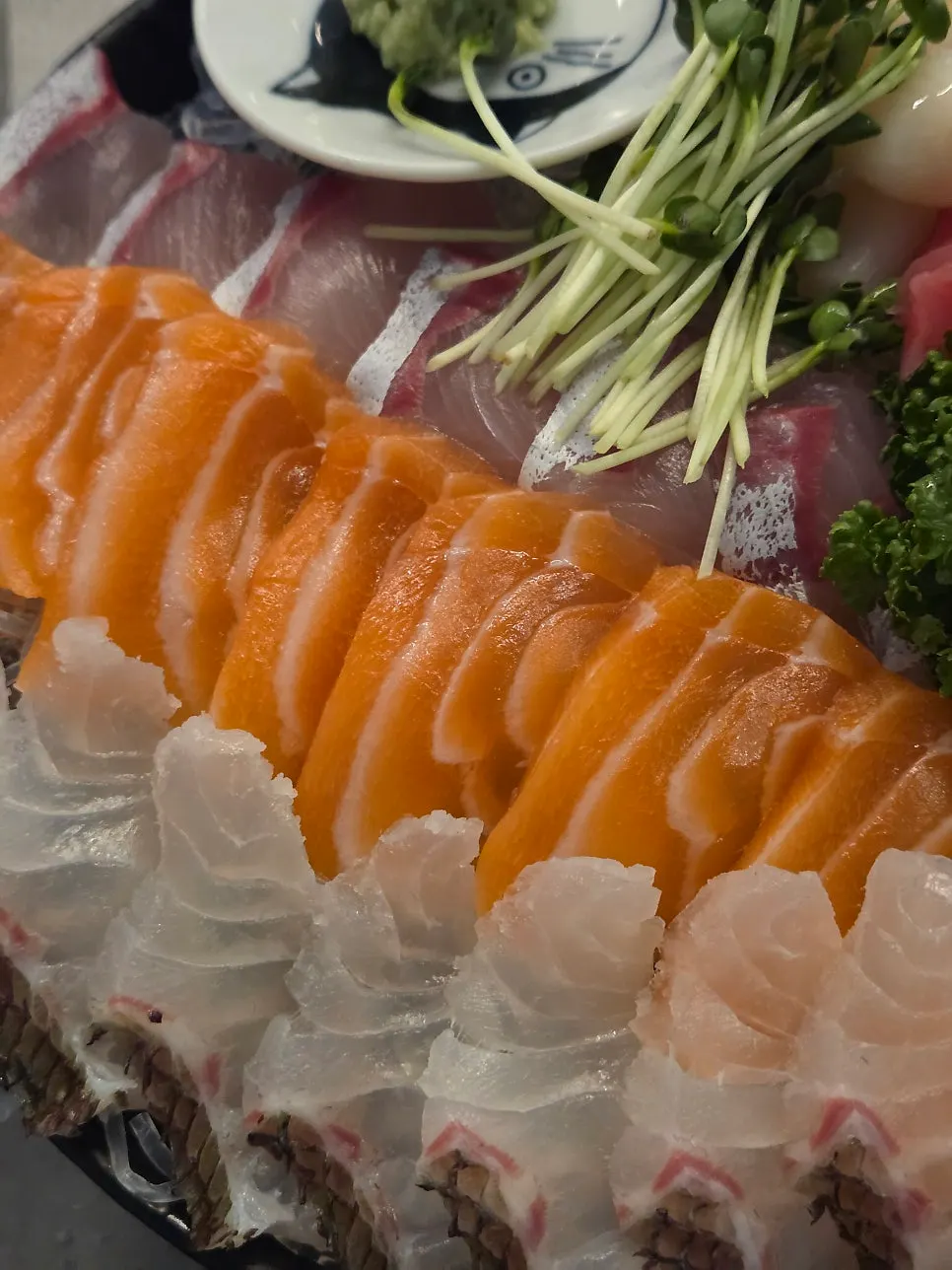 Plate of thinly sliced mixed sashimi