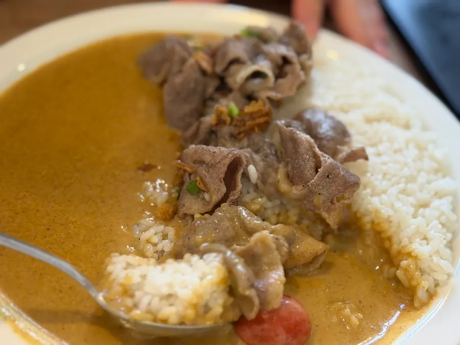Close-up of brisket cream curry topped with brisket