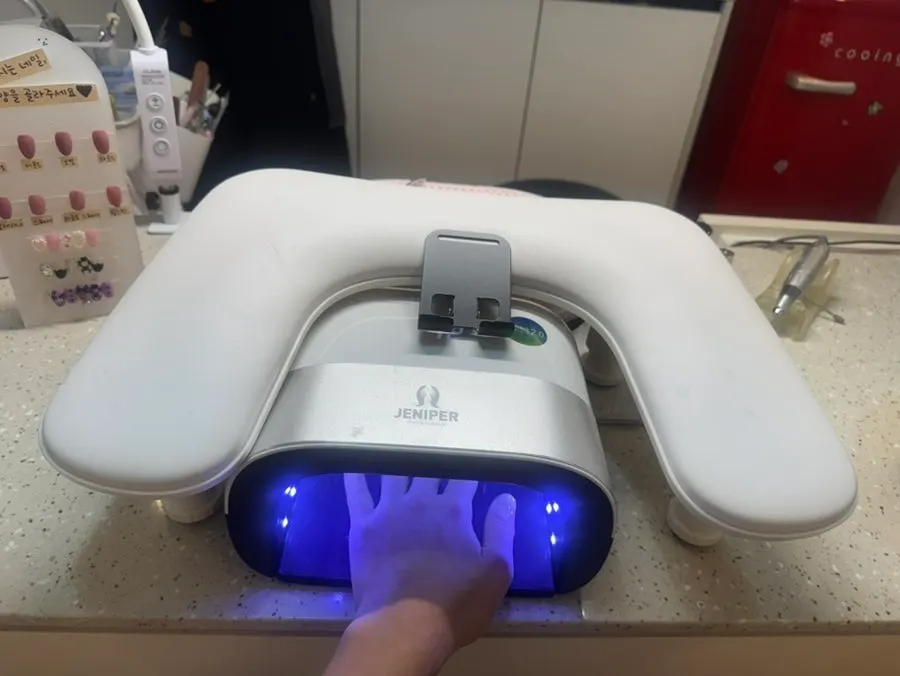 Hand receiving the nail treatment