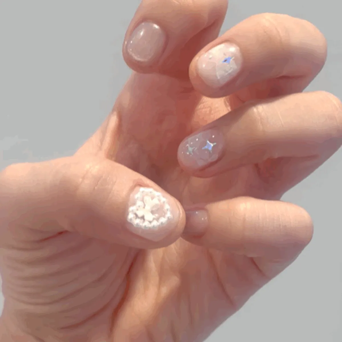 Final shot of the pink nails with lace and pearl accents