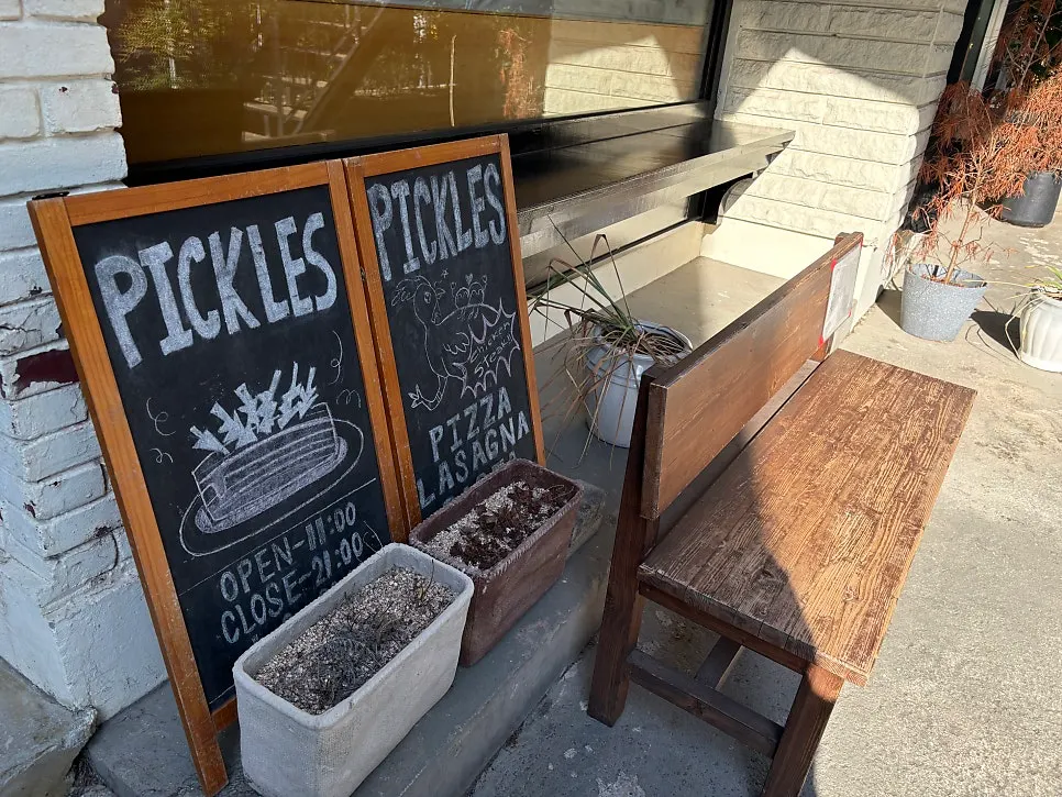 Alley entrance to Pickles with a green awning
