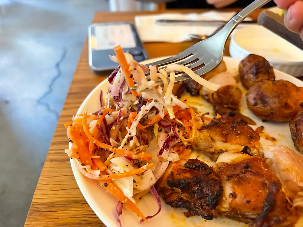 Roasted potatoes and coleslaw served with the chicken steak