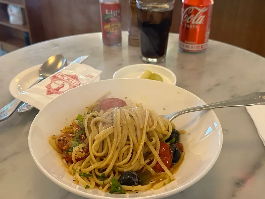 Close-up of oil-sauced puttanesca pasta