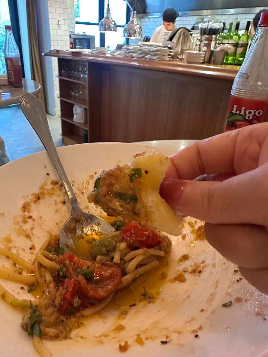 Pizza crust end dipped into pasta sauce