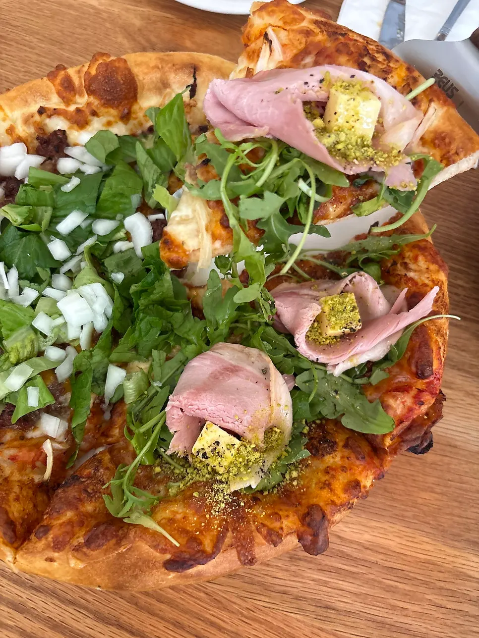 Pizza topped with ham and butter