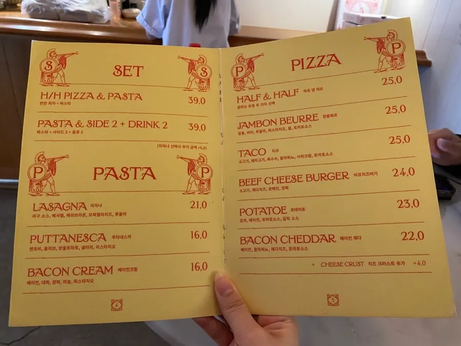 The Pickles menu board listing pizzas and pastas