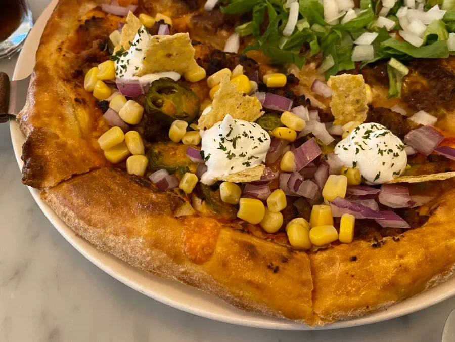 Close-up of the half-and-half pizza loaded with toppings