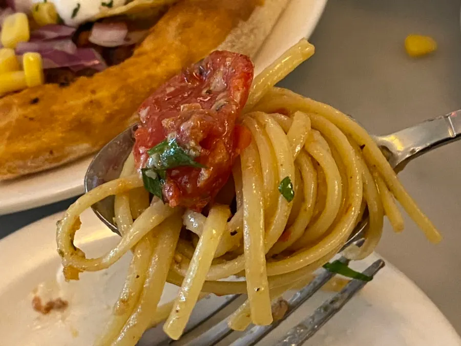 Puttanesca pasta noodles well-soaked in sauce