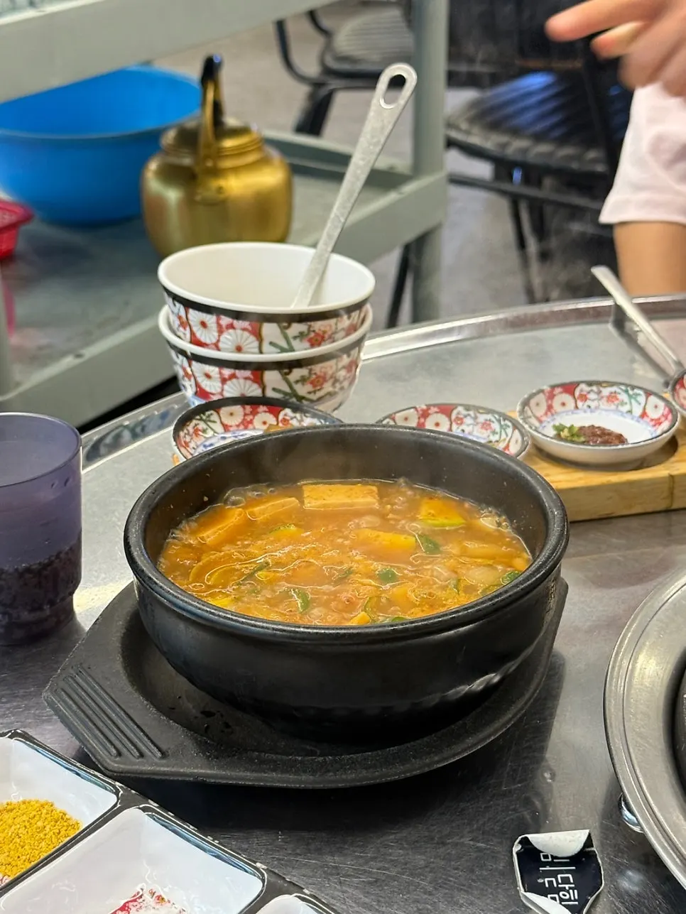 Bibim-myeon noodles piled on top of the grilled meat