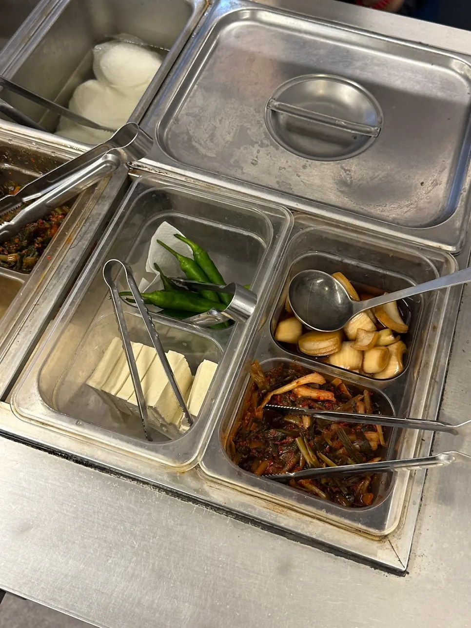 Side dishes and sauces at the self-serve bar