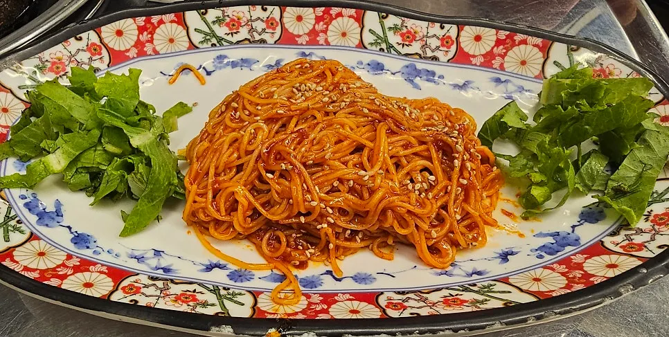 Spicy-tangy bibim-myeon served as a basic side dish