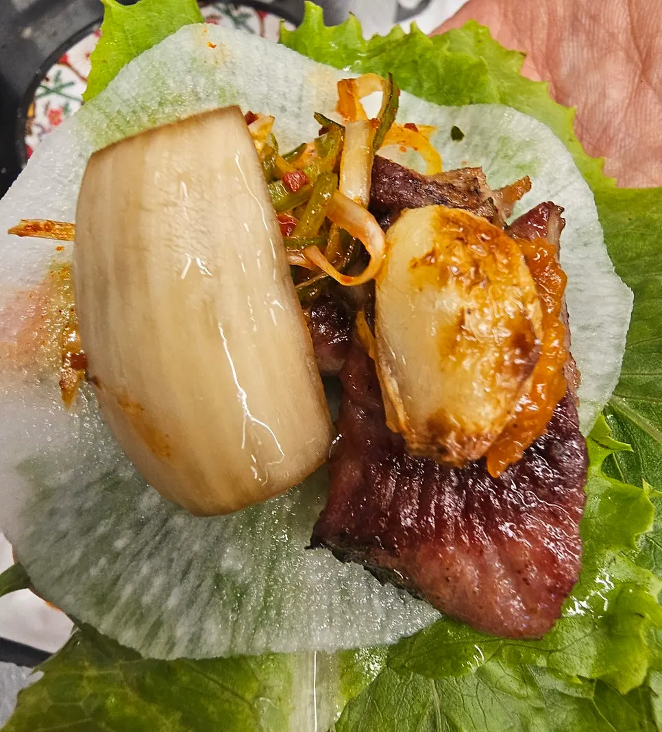 Grilled meat paired with scallion salad