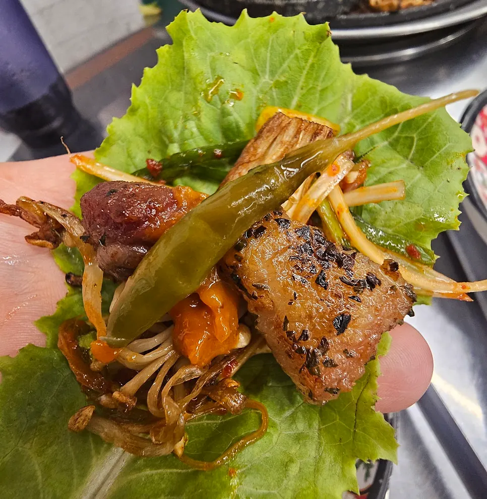 Rare pork wrapped in lettuce