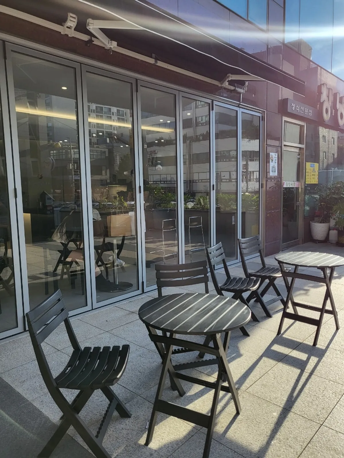 Outdoor terrace seating in front of Ibaba Coffee's entrance