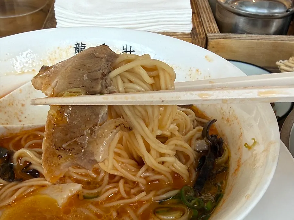 A bite of Ryusenso kara with chashu