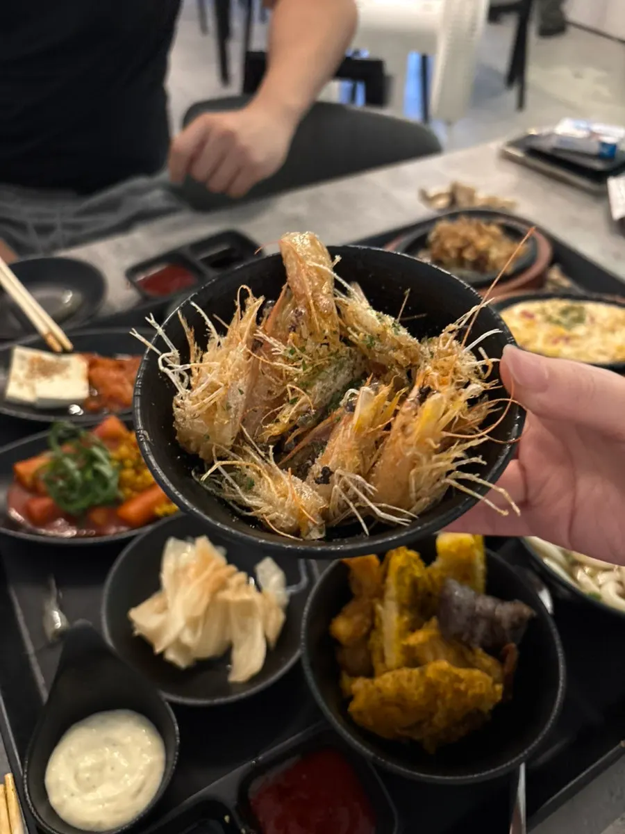 Plump raw shrimp meat picked up with chopsticks