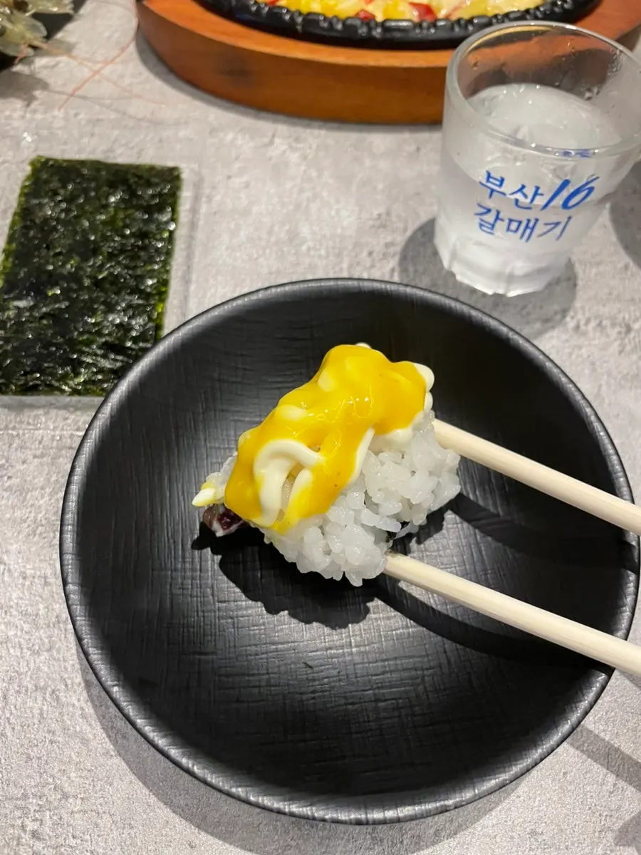 Okonomiyaki and corn cheese among the banchan spread