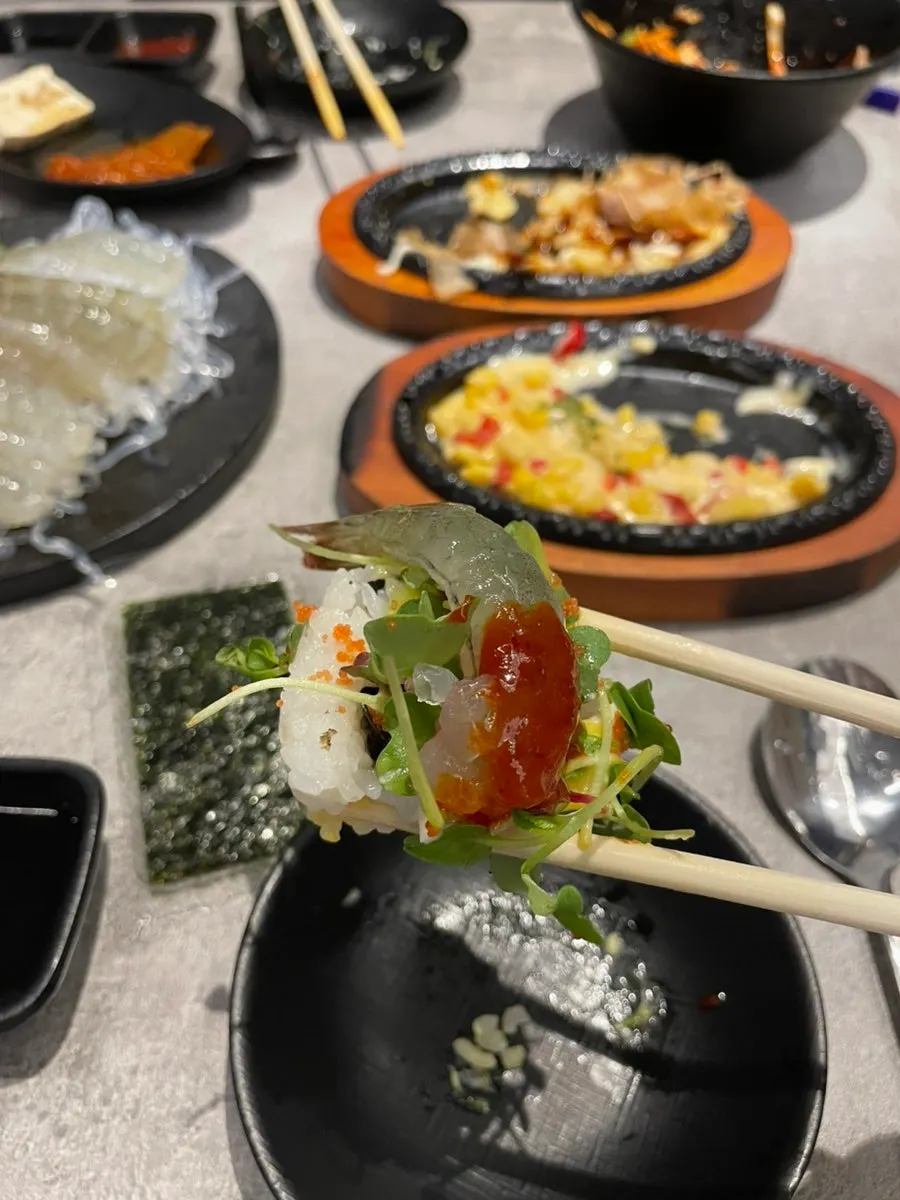 Raw shrimp sashimi spread paired with soju