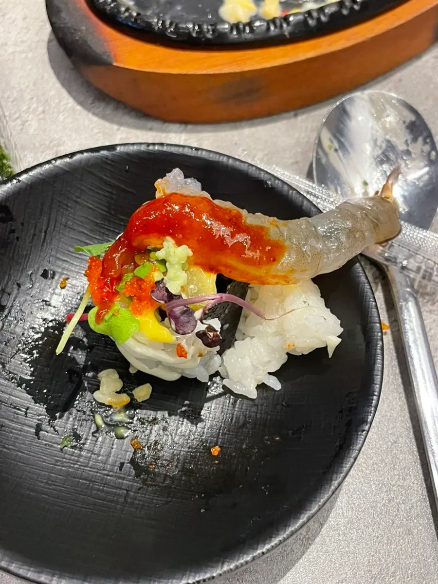 Raw shrimp piled on top of sushi