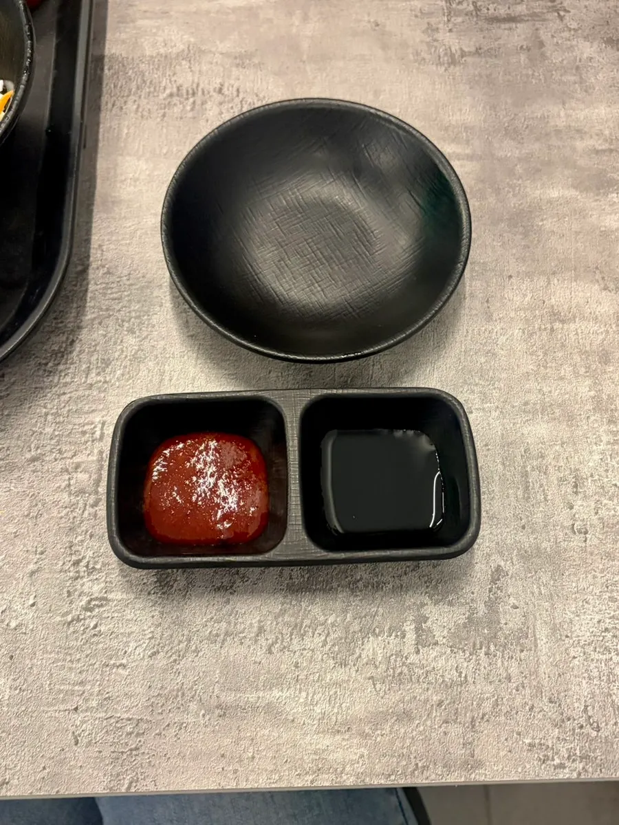 Soy sauce and vinegar-gochujang portioned onto individual plates