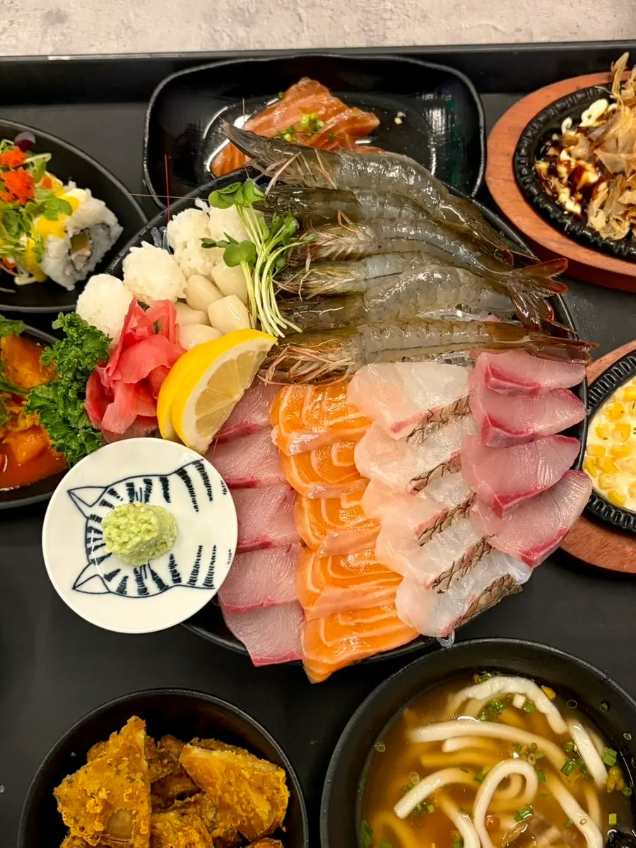 Assorted sashimi packed with raw shrimp and salmon