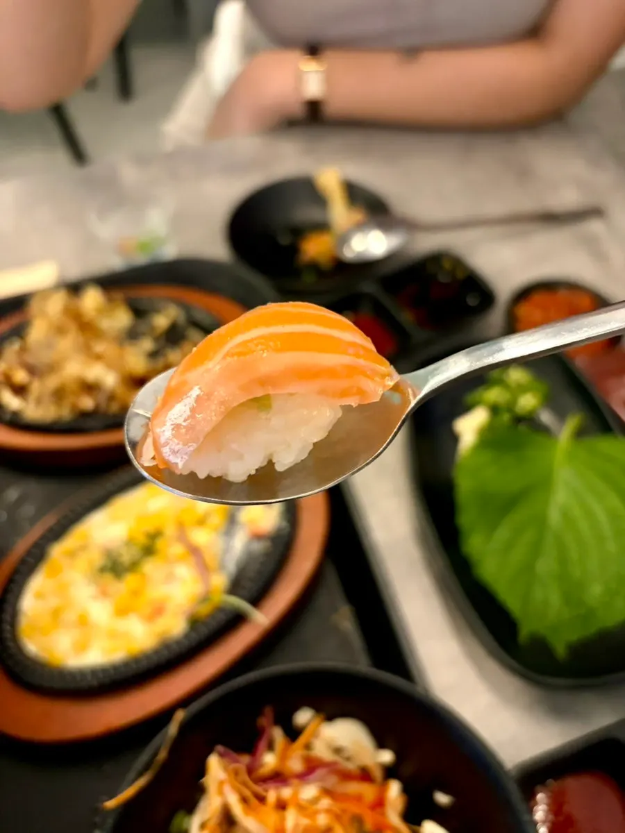 Instant salmon sushi made by placing salmon over rice