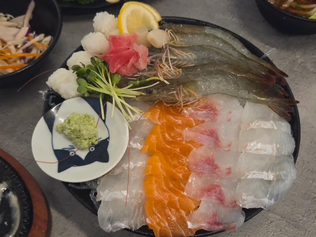 Raw shrimp and aged sashimi platter spread