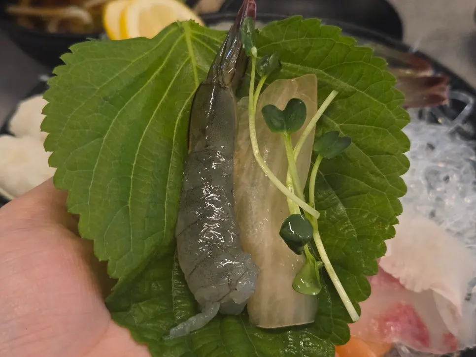 Plate of raw shrimp sashimi with heads removed