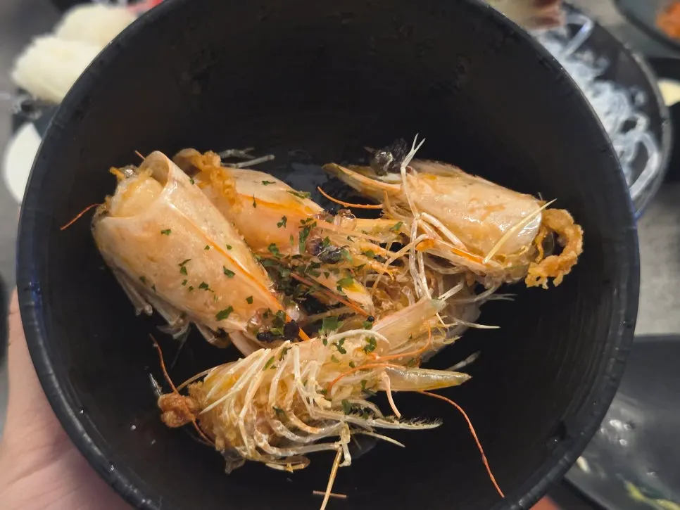 Bite-sized piece of raw shrimp sashimi