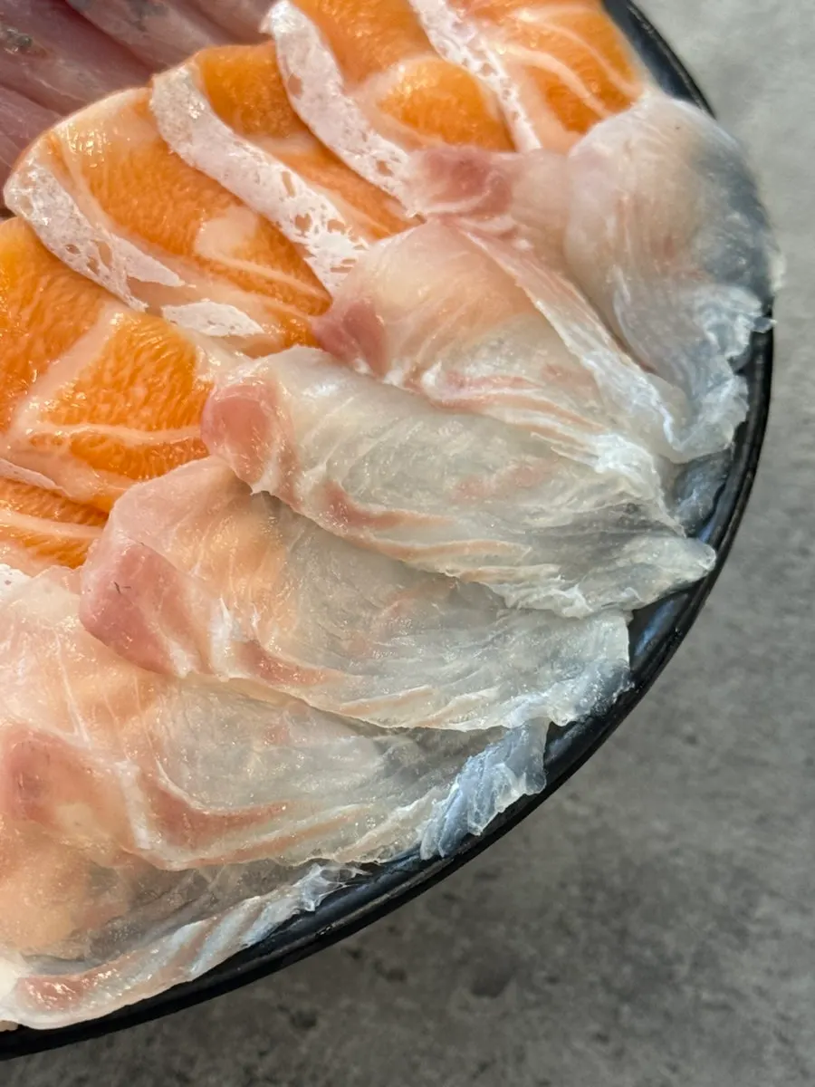 Picking up a piece of aged salmon sashimi