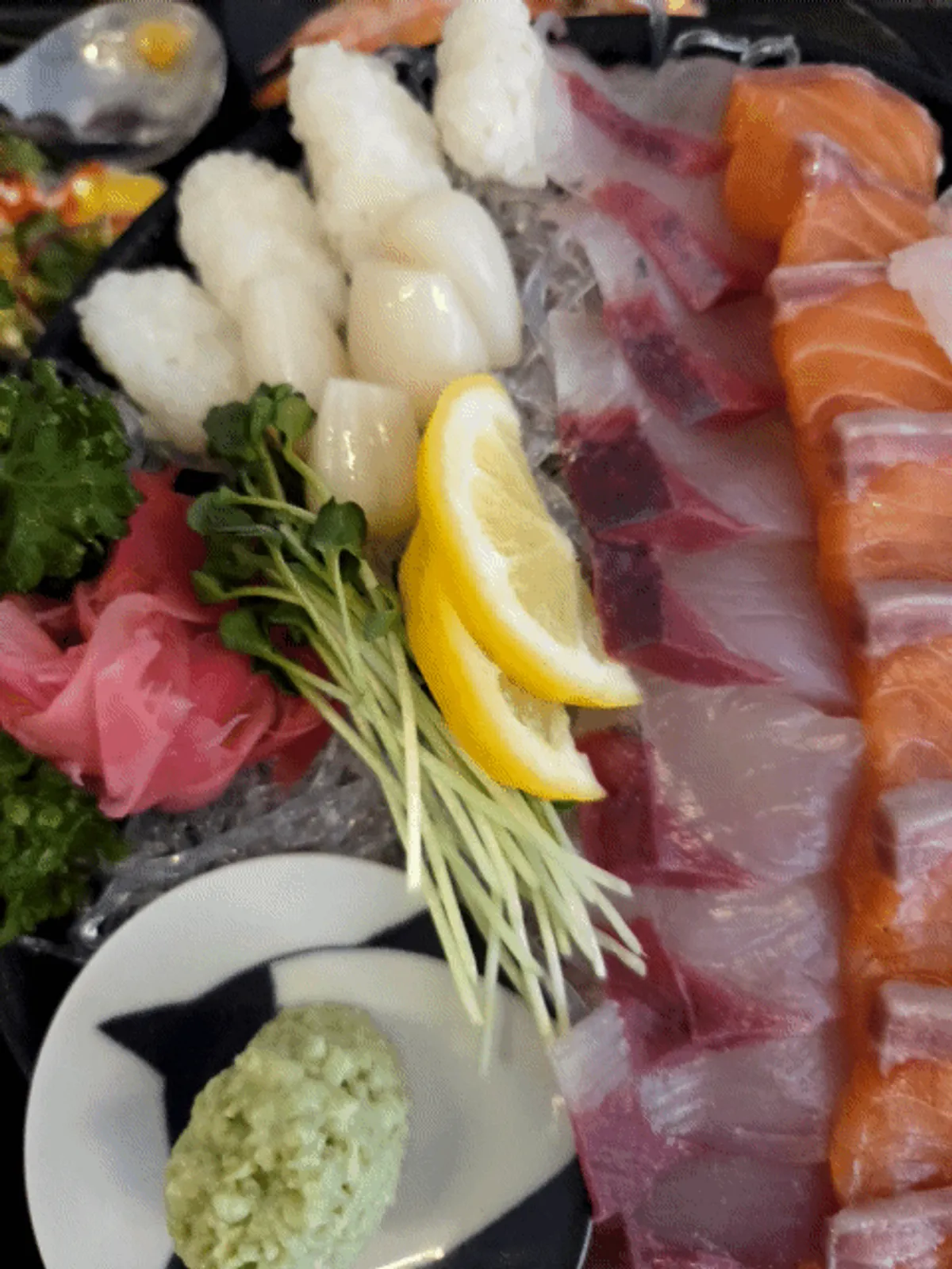 Aged assorted sashimi served with wasabi and soy sauce