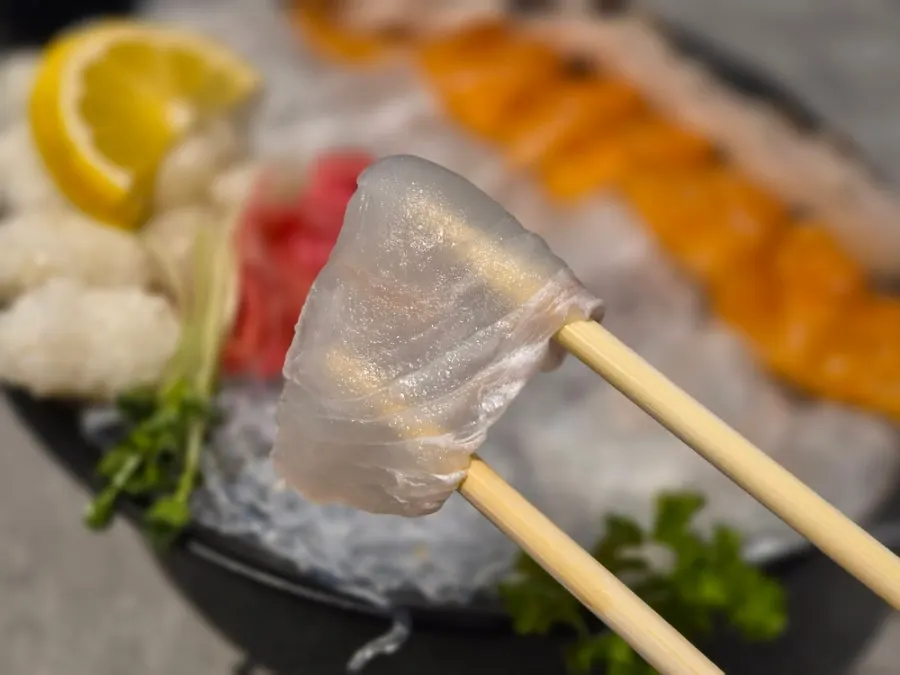 One thinly sliced piece of flounder sashimi