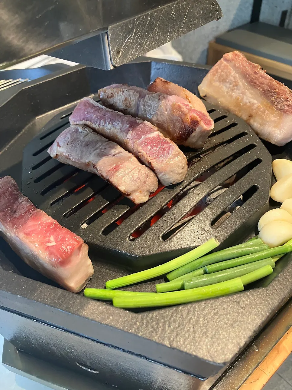 Garlic scapes grilled together with the meat over charcoal