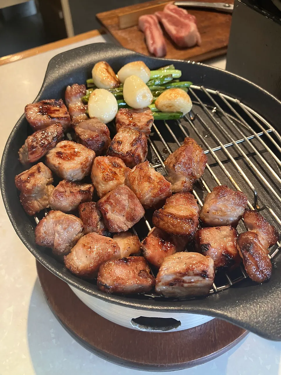 Pork belly grilled to a glossy finish over charcoal