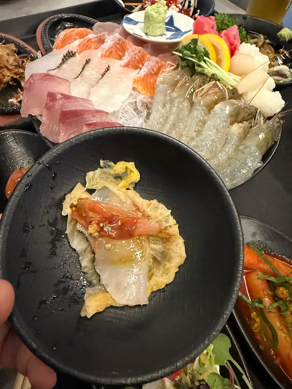 Mixed sashimi plate with salmon and white fish layered in tiers