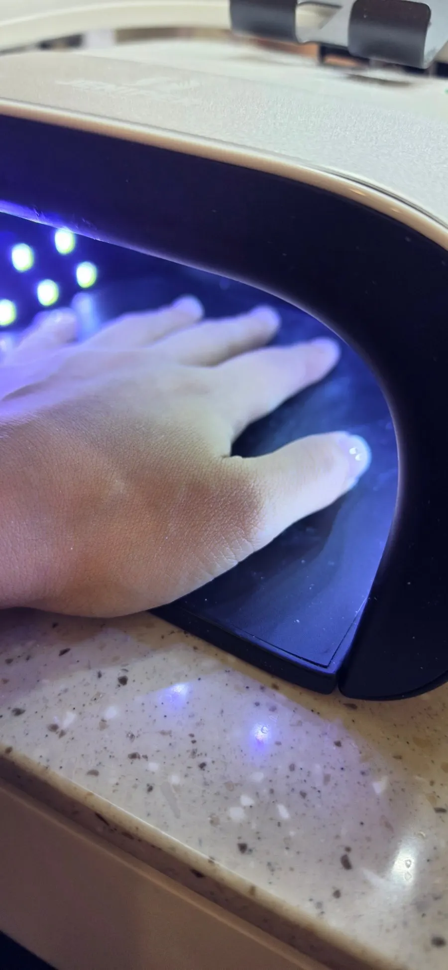 Filing around the nails with a machine during care