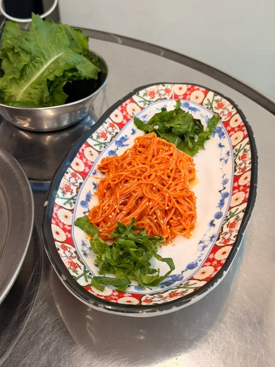 Complimentary spread including tofu kimchi and bibim noodles