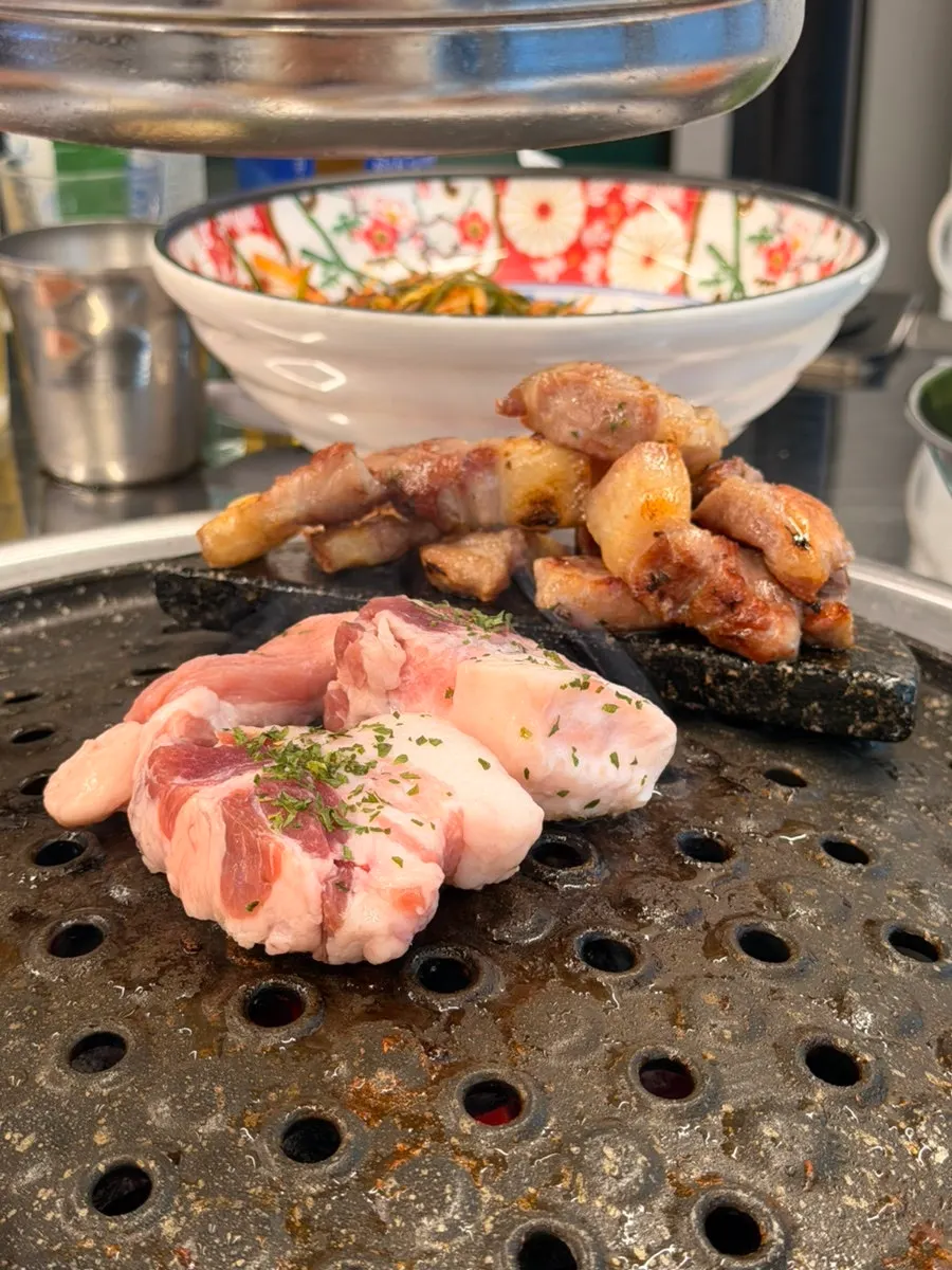 Rare pork cuts grilling over charcoal