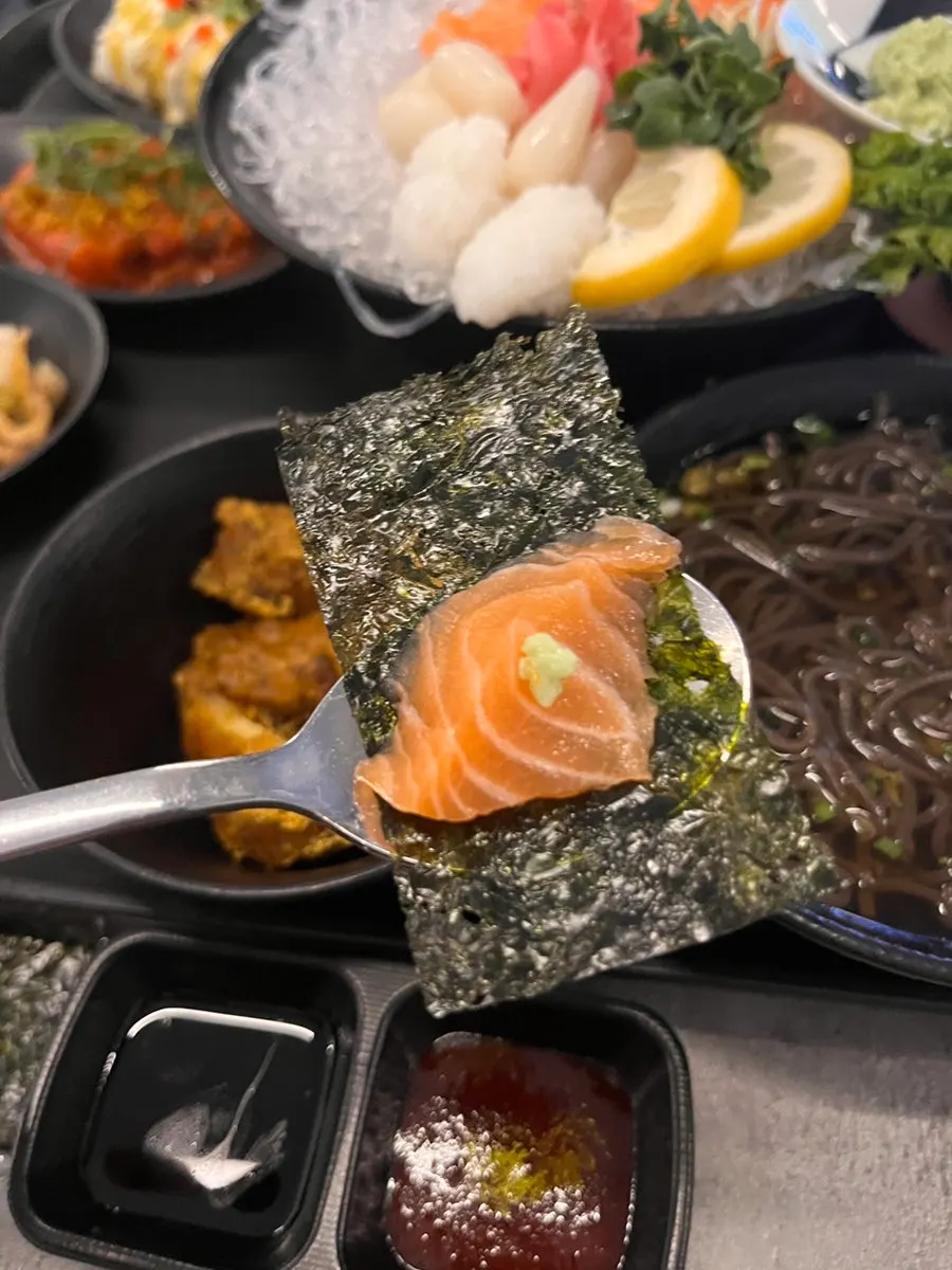 Salmon placed on top of sushi rice