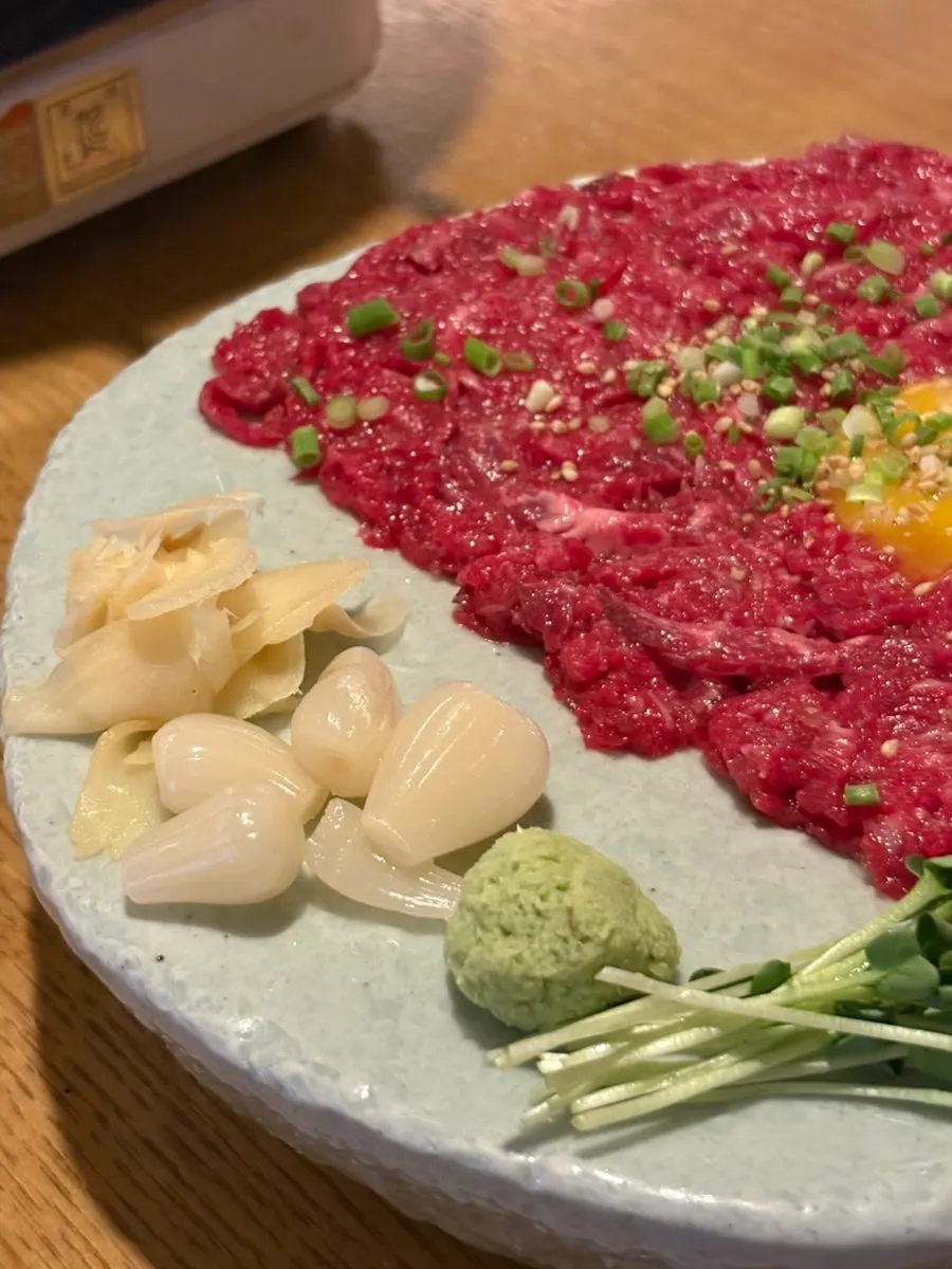 Korean beef tartare topped with egg yolk and scallions