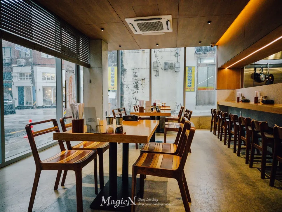 Bright interior of Katsu Gimseondo with floor-to-ceiling glass walls